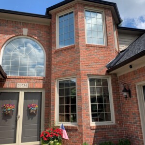 A brick home with tinted windows.