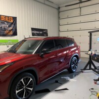 A red SUV with tinted windows by Eco Auto Glass LLC